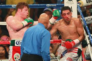 Canelo Alvarez connects with a left to the head of Josesito Lopez during their WBC super welterweight championship fight Saturday, Sept. 15, 2012 at the MGM Grand Garden Arena. Alvarez kept his belt with a fifth-round TKO.